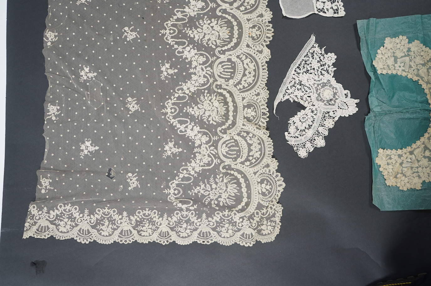 A late 19th century Brussels bobbin lace on net section of a wedding veil, Brussels bobbin lace collar, a point de gaz lace motif and two lengths of later bobbin lace trimming possibly Honiton with needle lace insertions